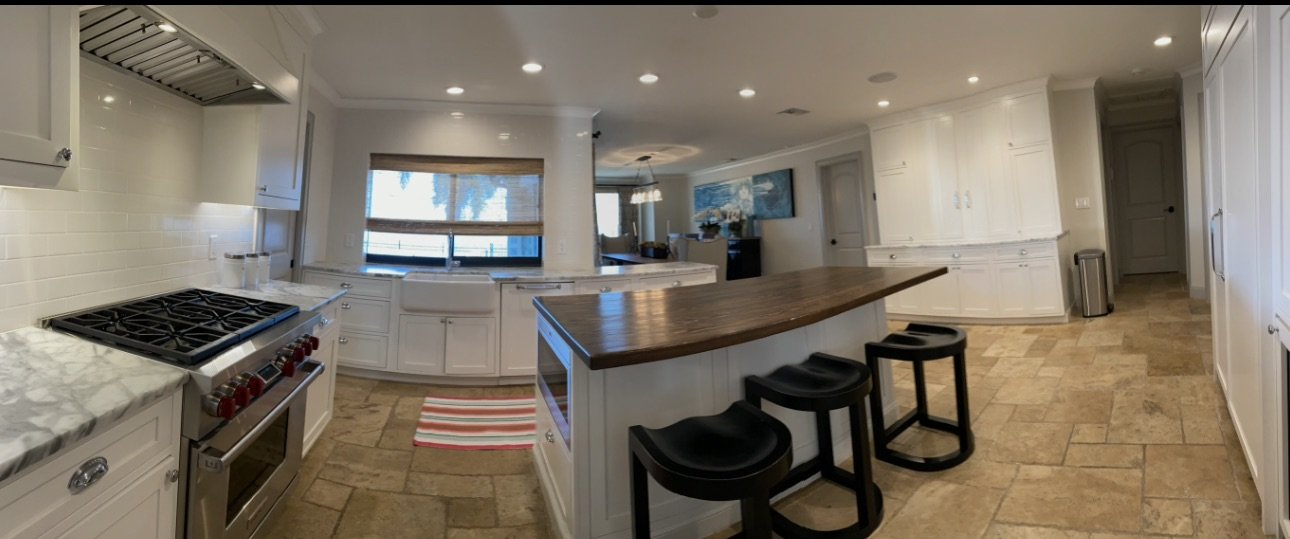 Open kitchen with island seating and stone floor