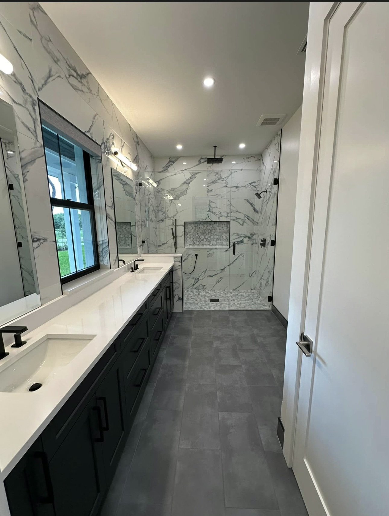 Bathroom with double vanity and walk-in shower