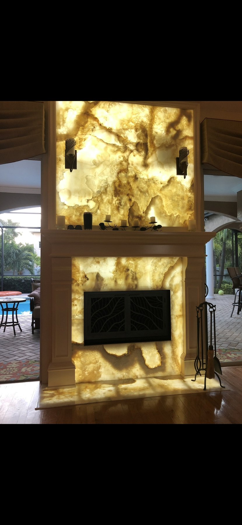 Stone fireplace with illuminated display shelving