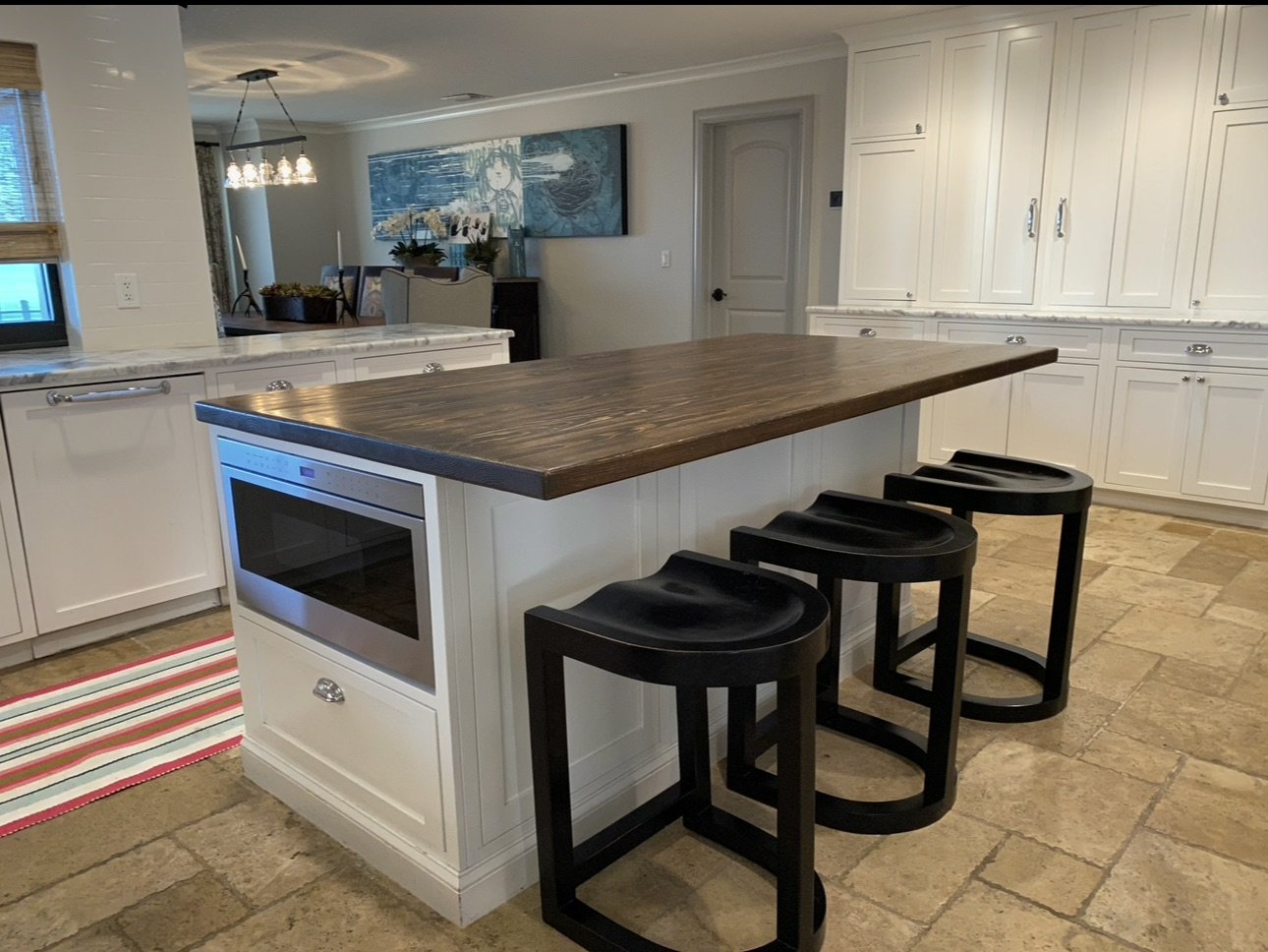 Kitchen island with wood countertop and bar seating