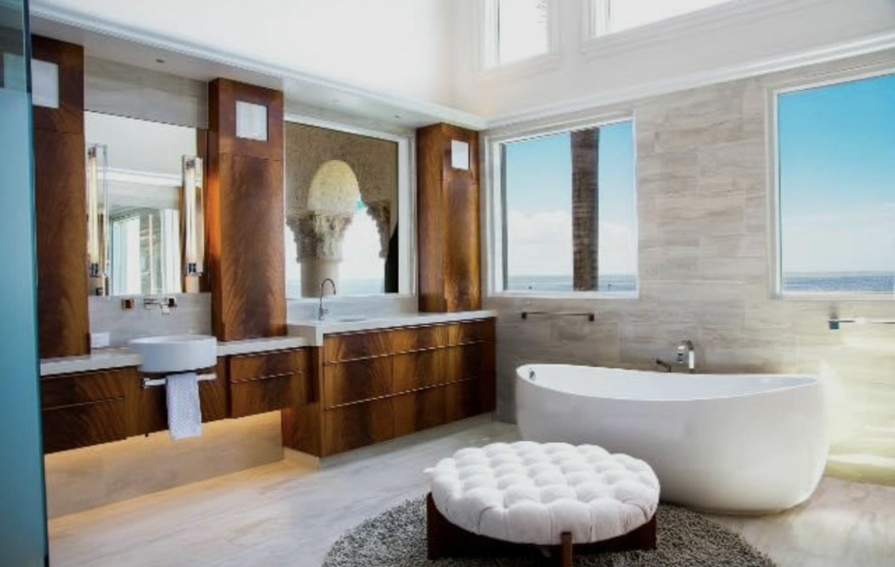 Bathroom with freestanding tub and wood cabinetry