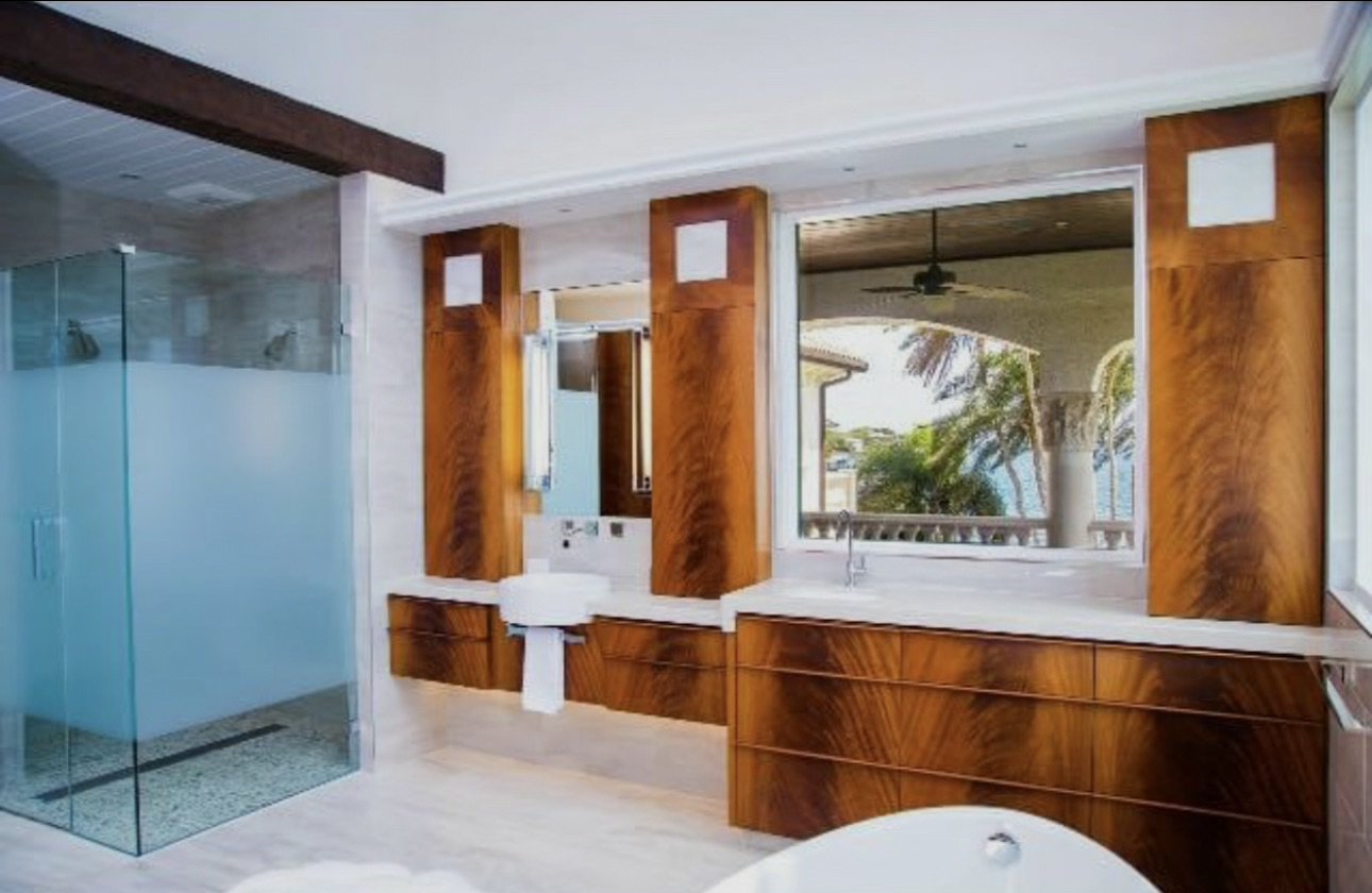Bathroom with wood cabinetry and glass shower