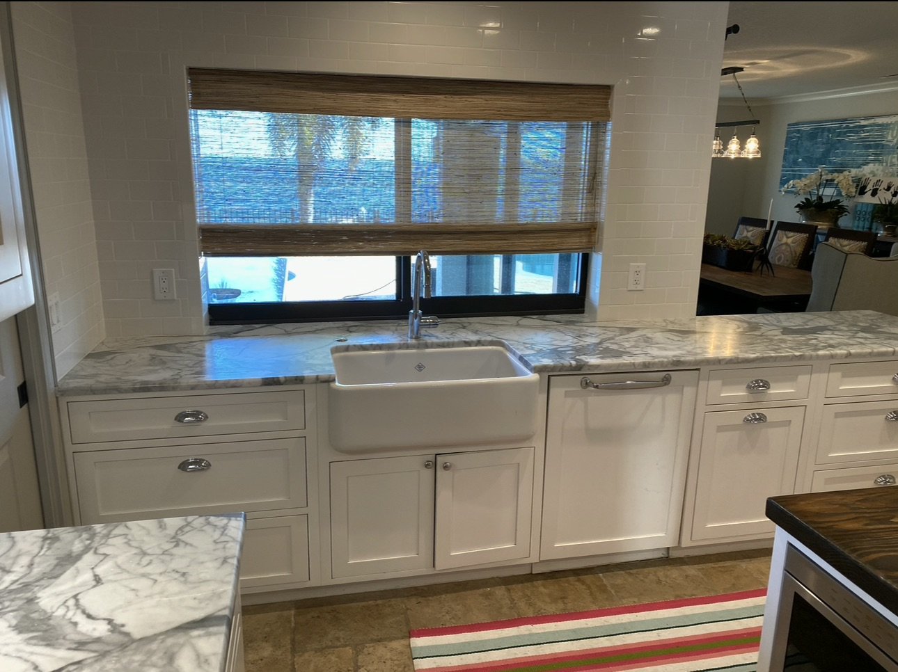 Kitchen with white cabinetry and stone countertops