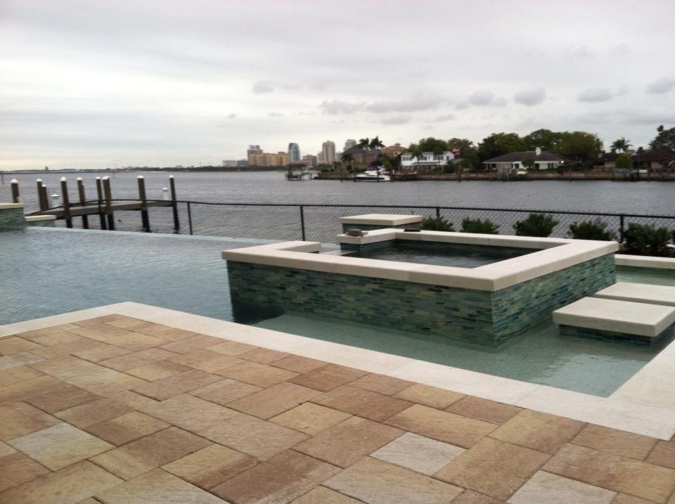 Waterfront pool terrace with raised spa