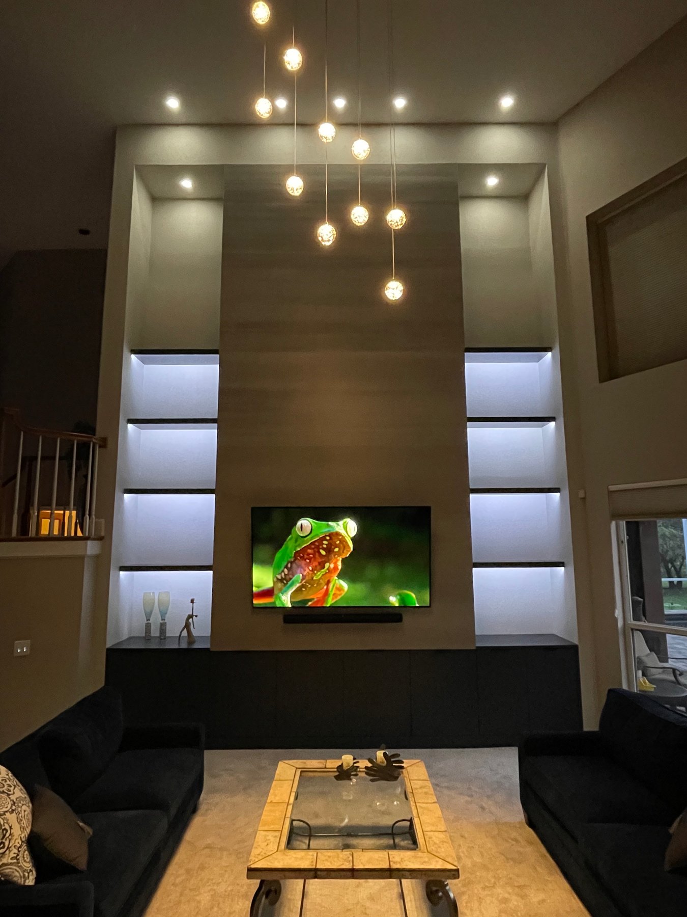 Living room with fireplace and double-height media wall