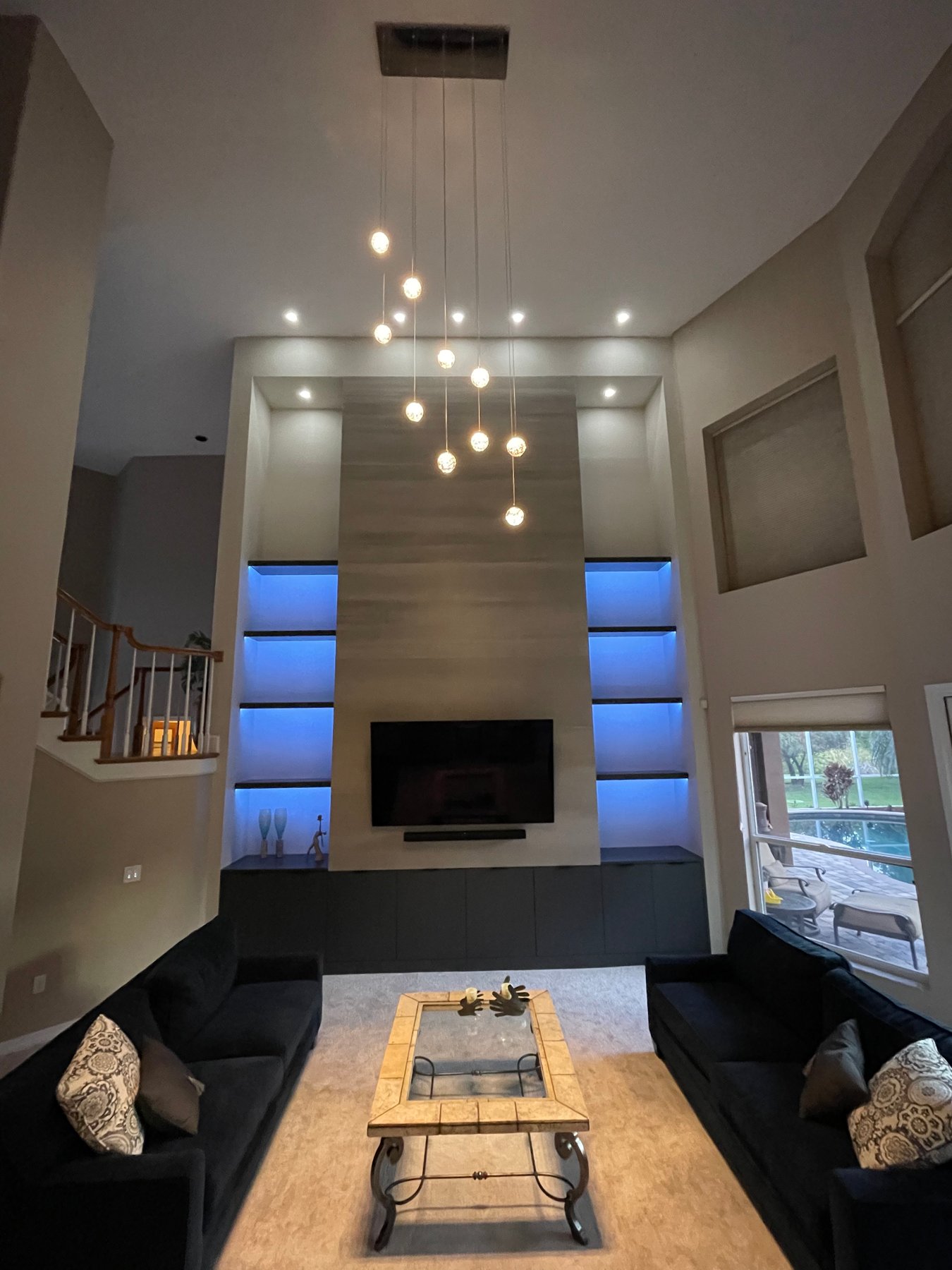 Double-height living space with illuminated media wall