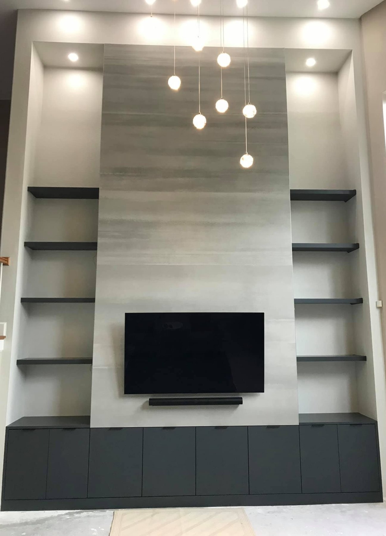 Built-in media wall with shelving and recessed lighting